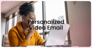 Woman in yellow sweater looking at computer screen with text Personalized Video Email
