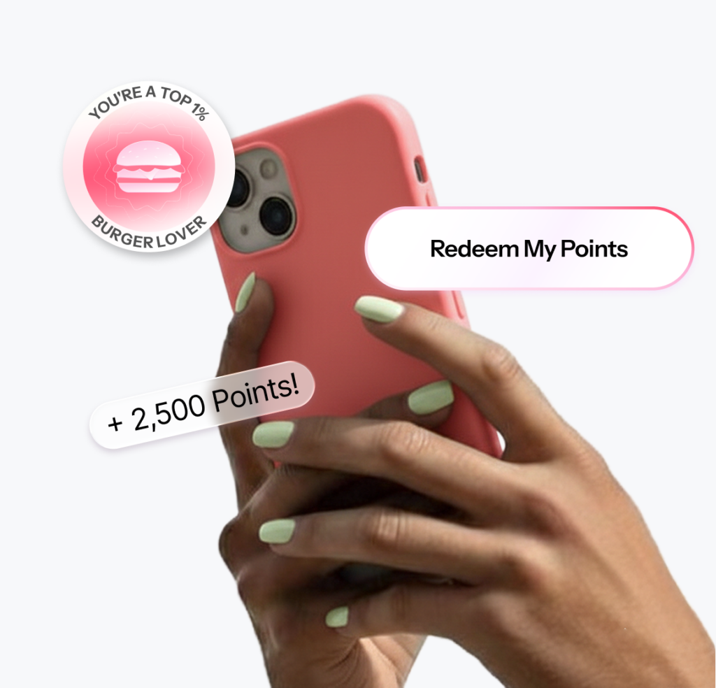 A hand holds a phone showing a Redeem My Points button and a plus 2,500 points reward.