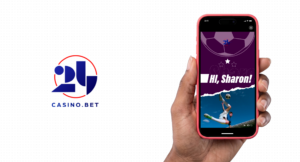 24Casino.bet case study card with the 24 Casino wordmark beside a hand holding a phone showing a sports frame that greets Hi, Sharon.