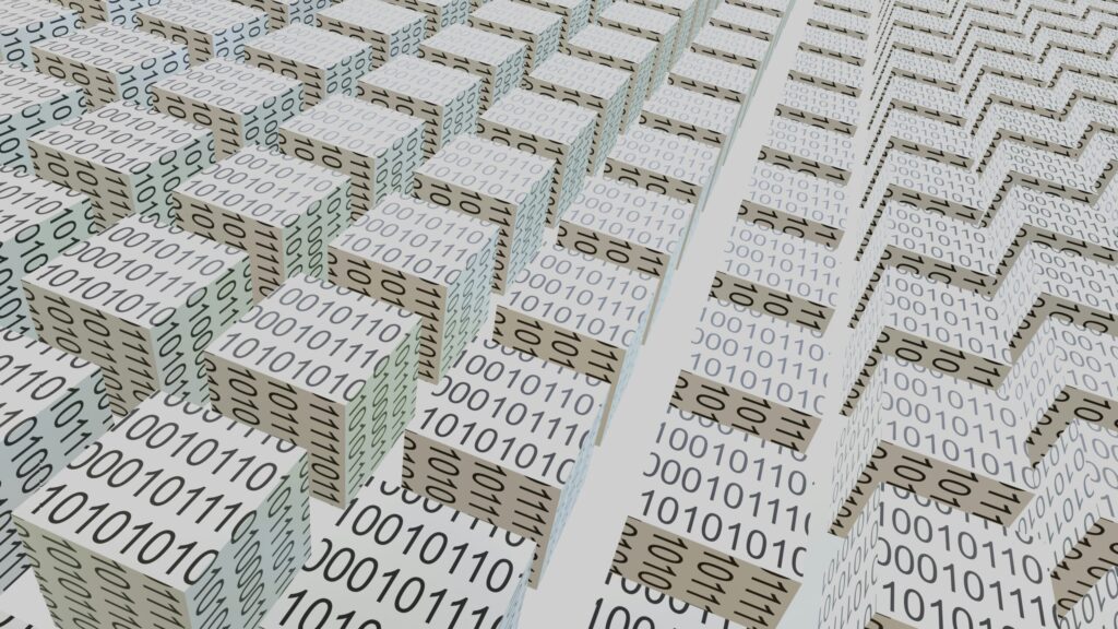 Stacked paper sheets printed with rows of binary ones and zeros, shot at an angle.