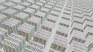 Stacked paper sheets printed with rows of binary ones and zeros, shot at an angle.