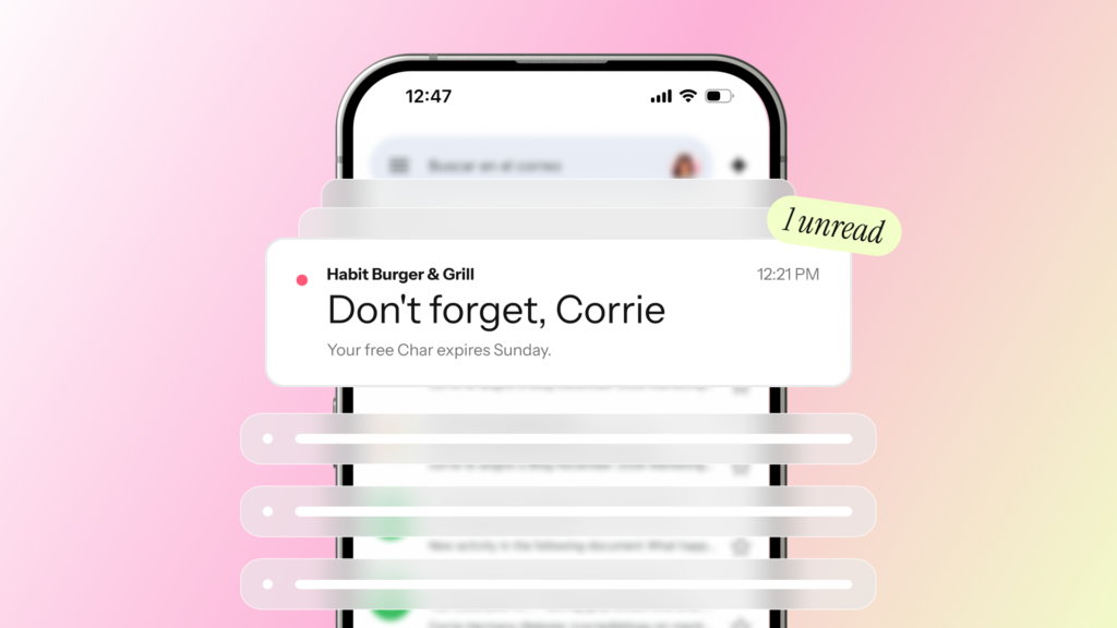 Phone showing an email notification that reads Don't forget, Corrie, above a blurred inbox list on a pink gradient.